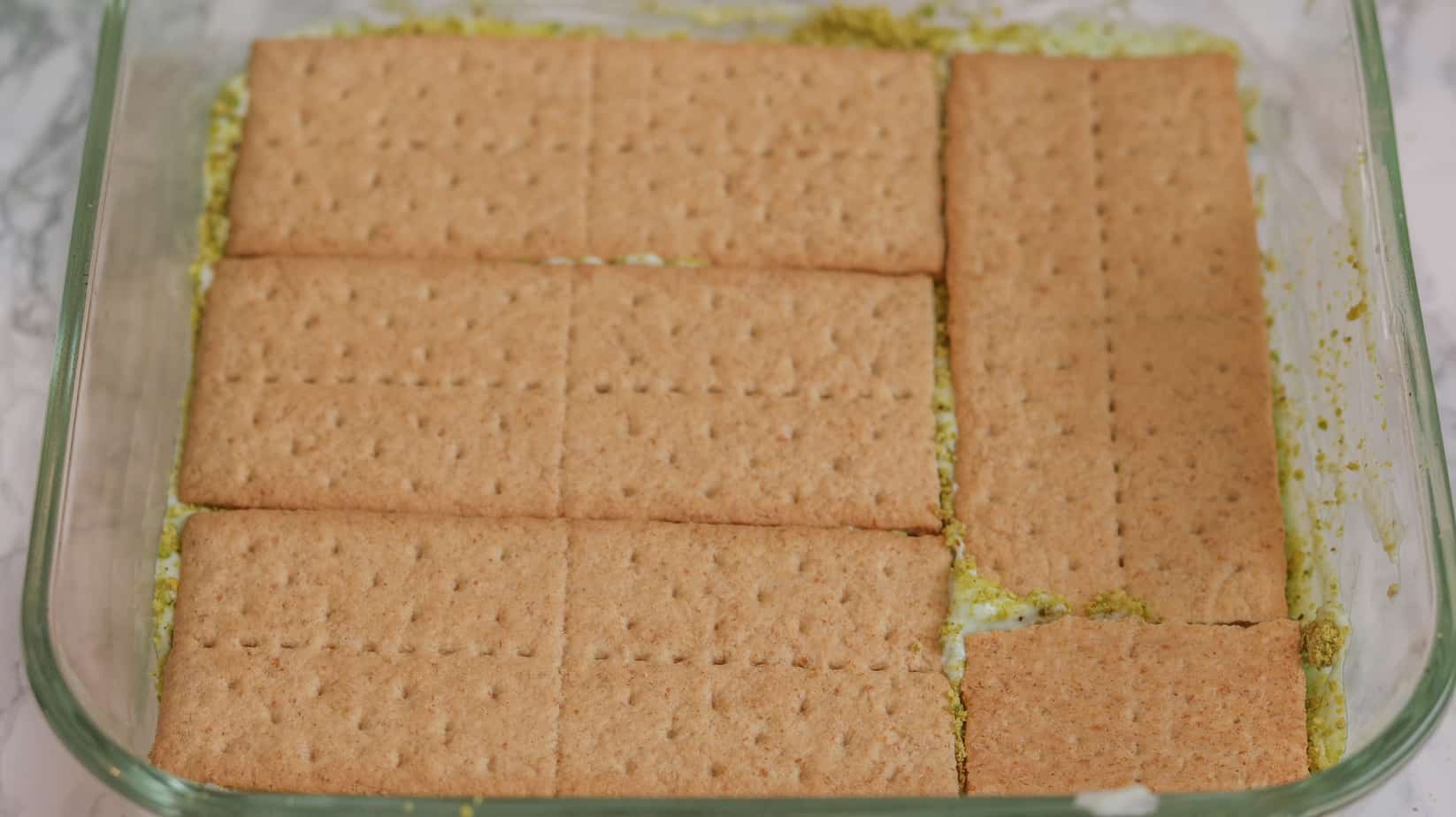 layers of graham crackers and whipped cream and other ingredients layered beautifully to form the best Pistachio Icebox Cake