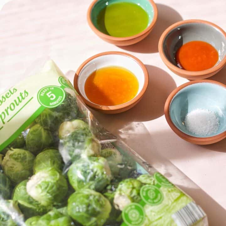 You only need Brussel sprouts, honey, olive oil, Sriracha sauce, and a pinch of salt to make this delicious side dish.