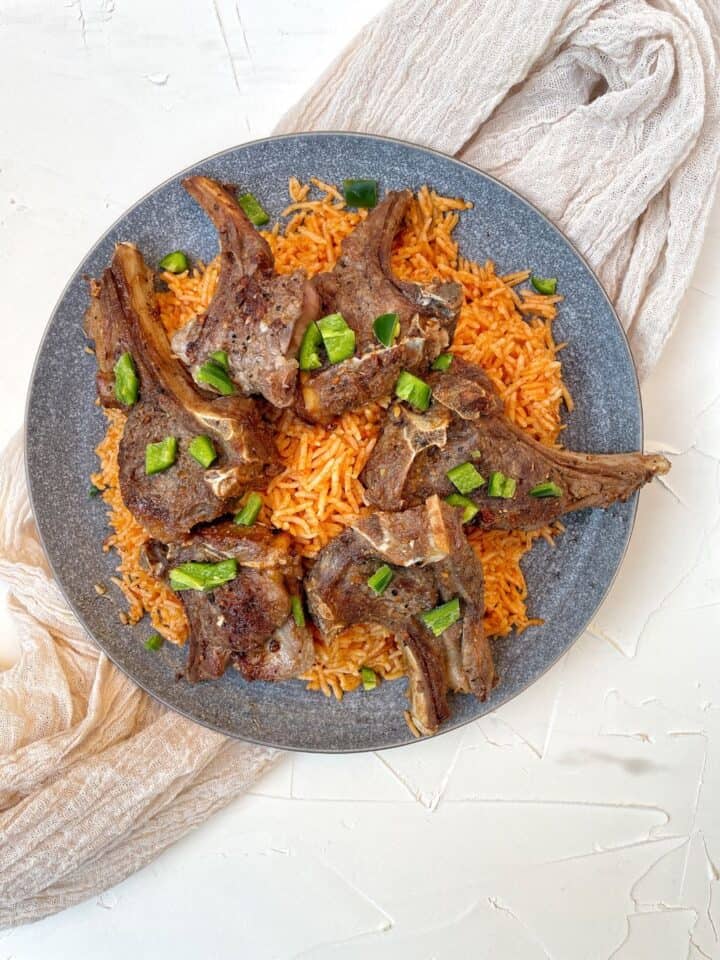 Marinated Baby Lamb Chops are served on a yummy bed of rice.