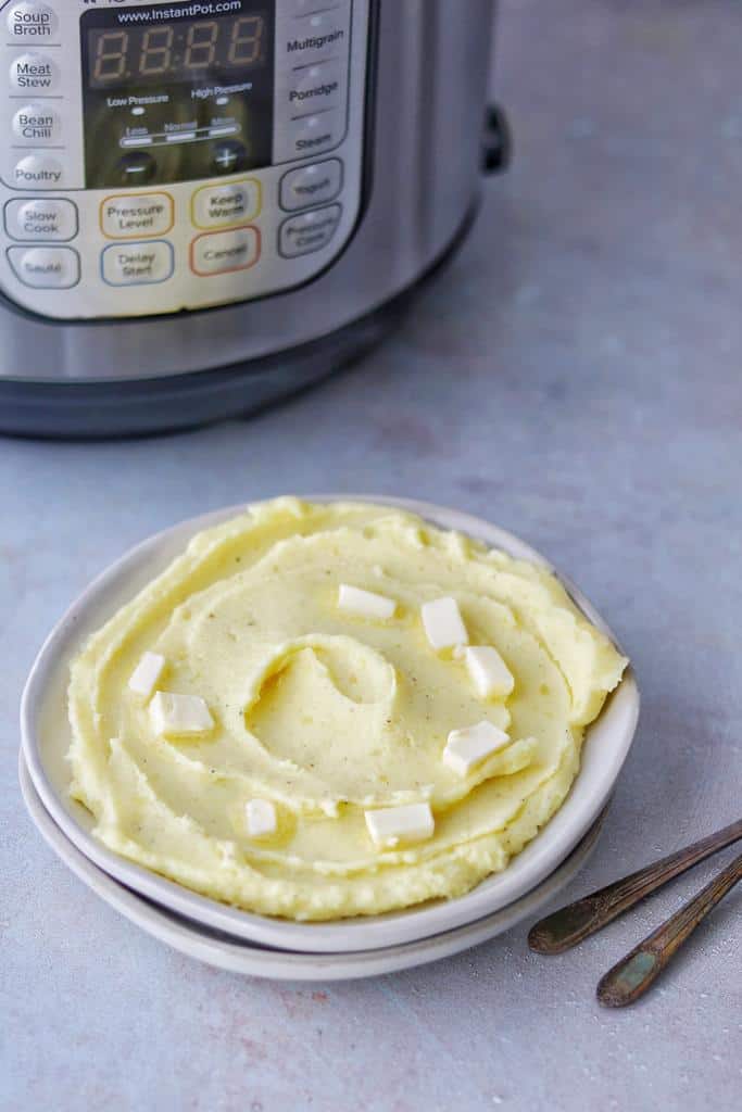 instant pot Yukon gold mashed potatoes (No Drain) with a creamy fluffy texture served with yummy butter piece son the top 