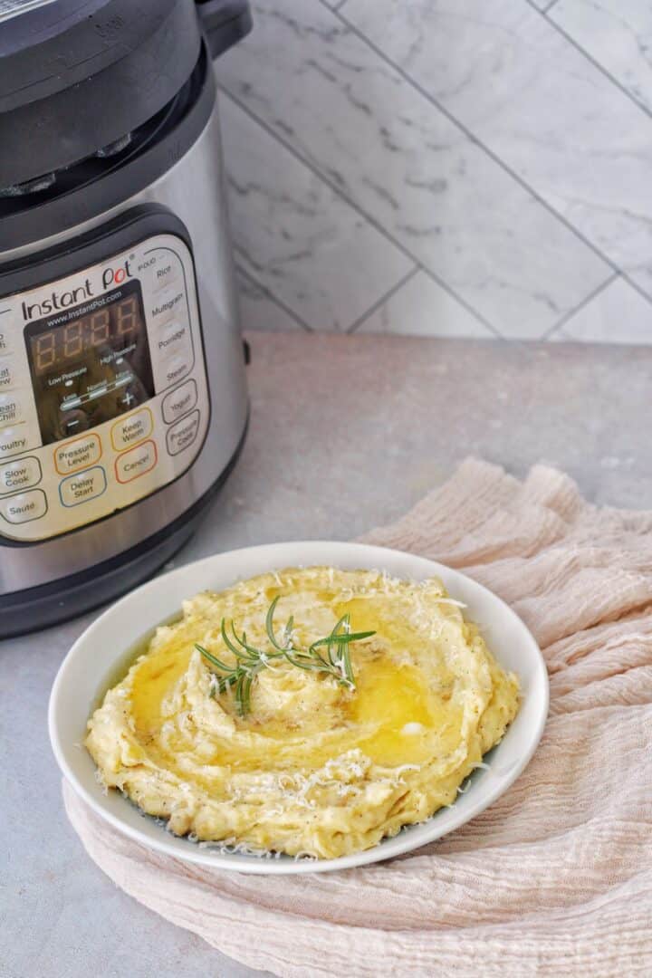 skin on instant pot yukon gold mashed potatoes served with olive oil, parmesan cheese, and rosemary on the top