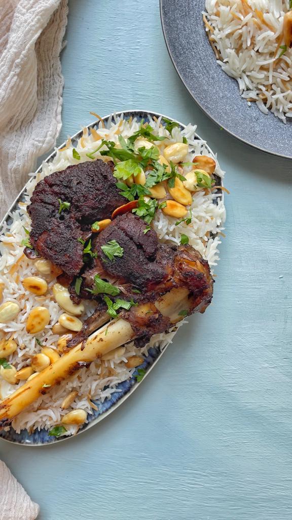 A perfectly roasted goat shoulder served on a bed of vermicelli rice makes the perfect weeknight meak.