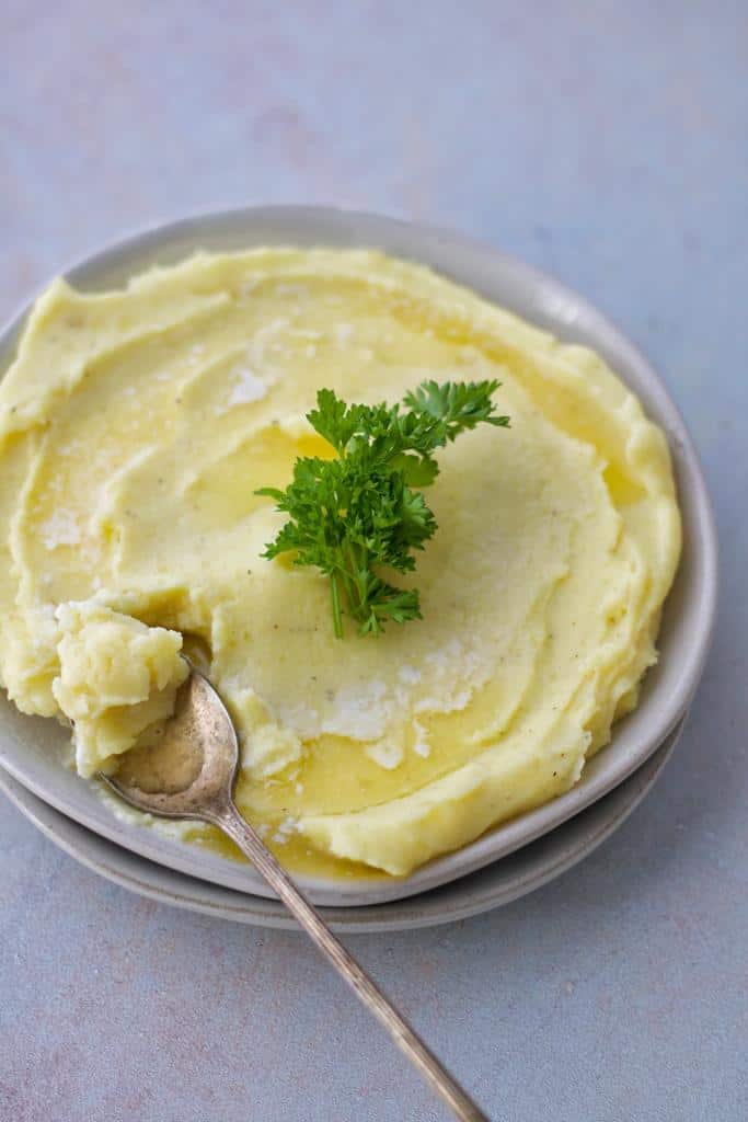 creamy and buttery flavor of Yukon gold mashed potatoes made using an instant pot, and served warm as a side dish with melted butter and 
soft parsley sweat
