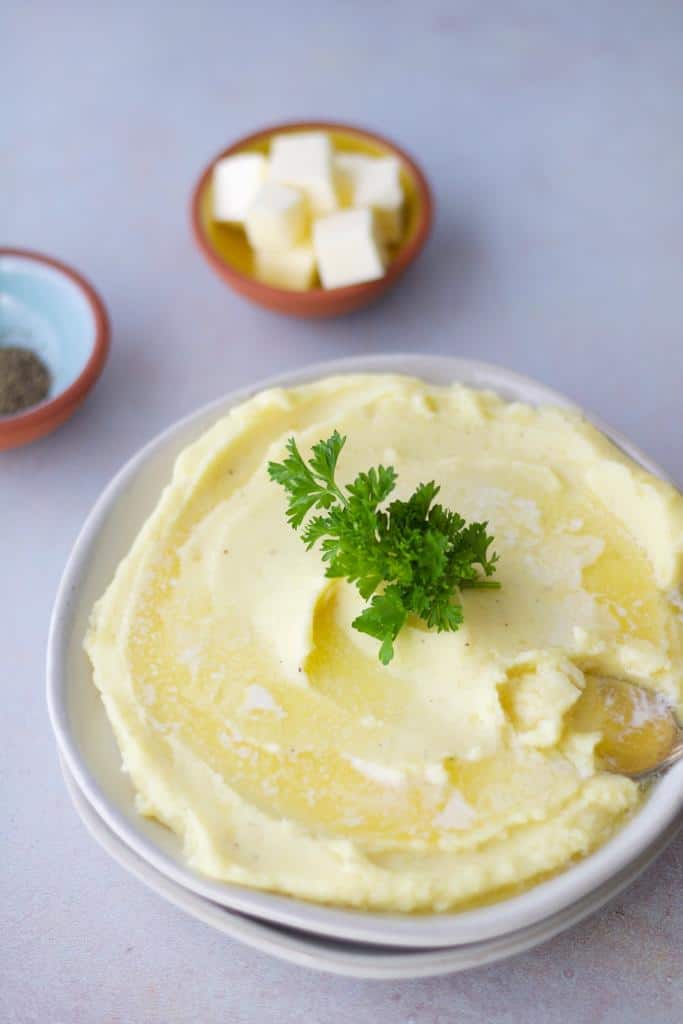 an amazing nutritious side dish of Yukon gold mashed potatoes served warm with extra butter and soft parsley on the top