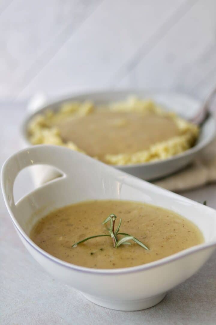 The vegetable broth gravy is a tasty bowl of different ingredients like onions, garlic and rosemary in a roux. It is a great adding to your table.