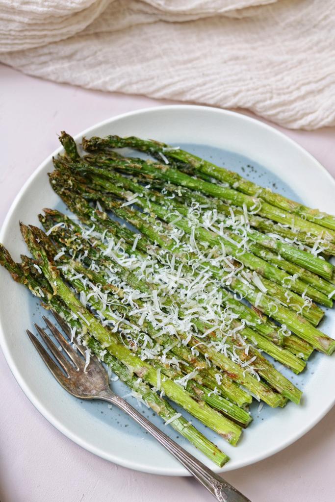 The asparagus are set in a large plate with a sprinkle of parmesan on its tender bottom and crispy spears. It looks so tasty!