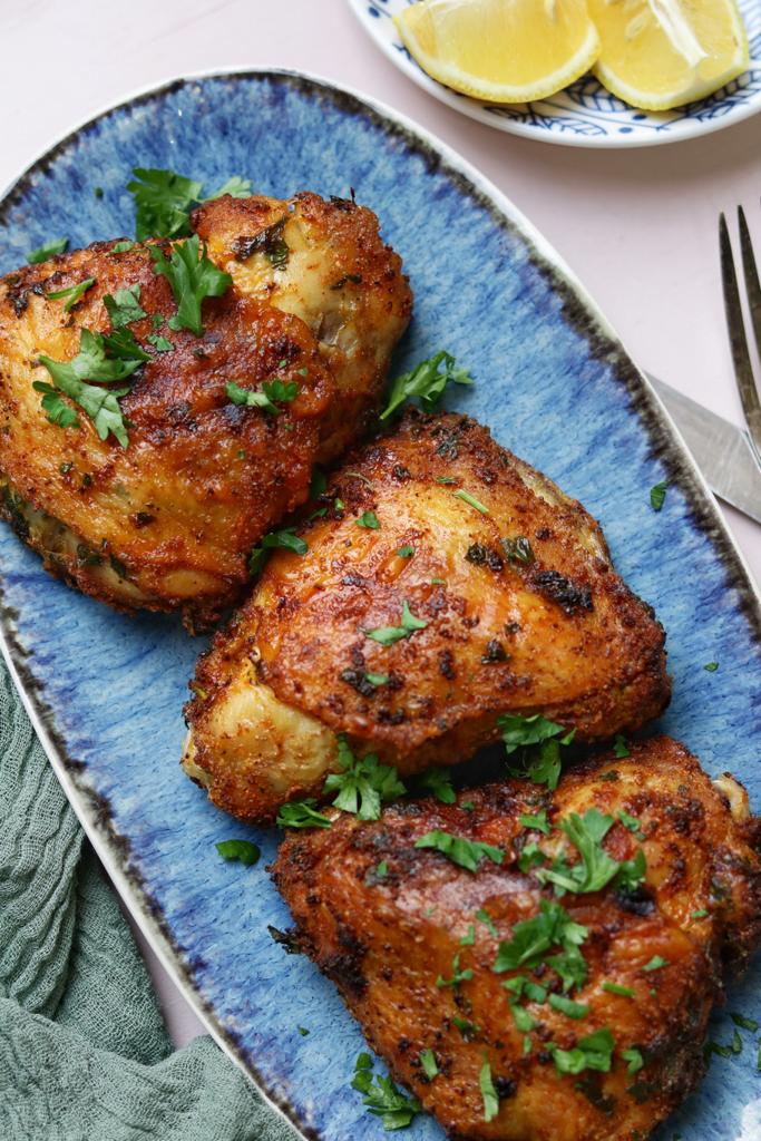 Tender and juicy air fried chicken served with lemon cutlets and garnished with fresh parsley finely chopped. 
