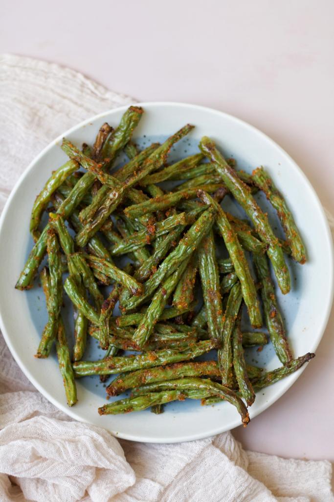 A perfect side dish for many meals made with green beans, olive oil, garlic powder, onion powder, paprika, and black pepper. They have crispy texture and spicy flavor.