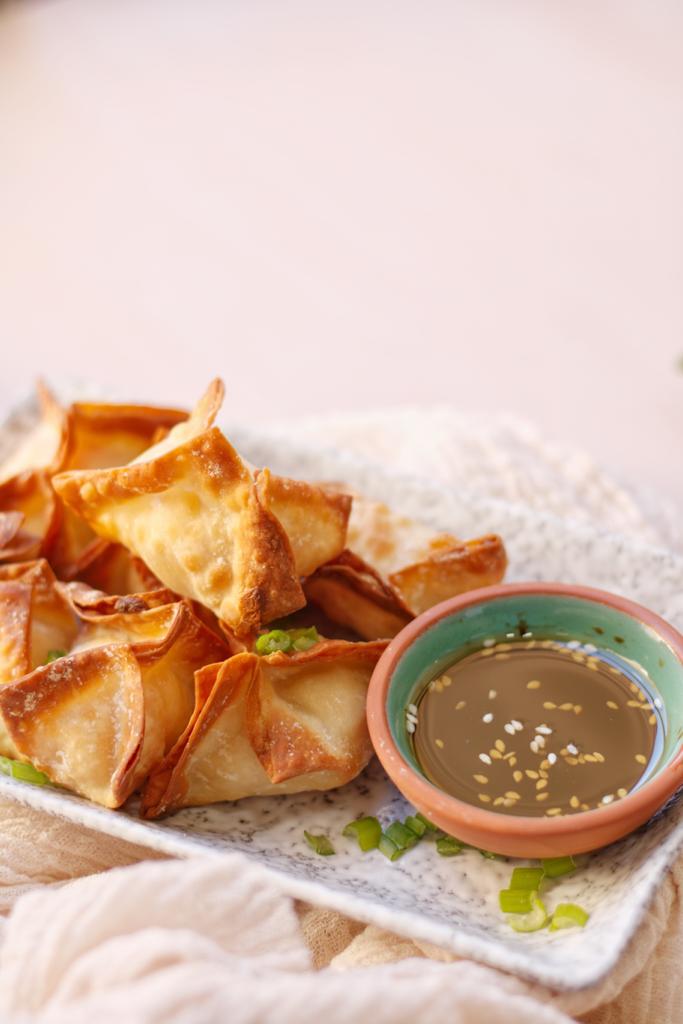 These wontons stuffed with cream cheese and imitation crab meat are super crunchy, delicious, and easy to make at home.