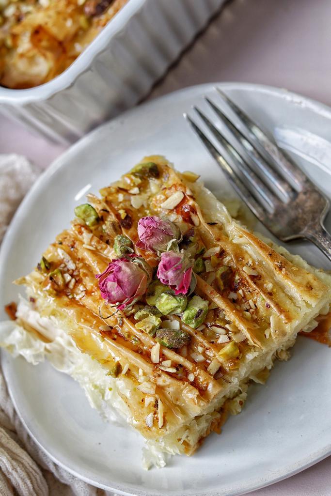 Crispy layers of phyllo dough flavored with sweetened milk, topped with pistachios, and drizzled with simple dessert. A dessert that the whole family will enjoy.