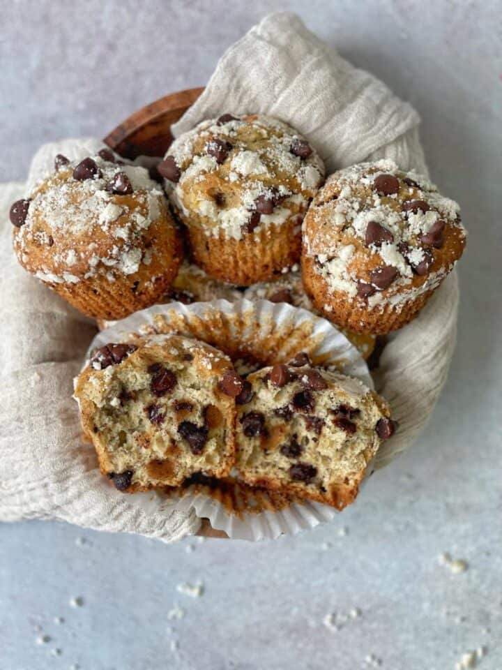 Banana muffins rich in moist chocolate chips and topped with white streusel crumb make the perfect snack!