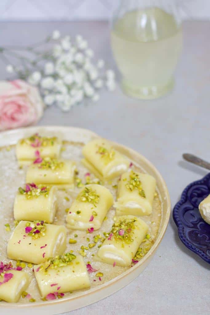 Halawet El Jibn dessert is a delectable sweet cheesy rolls that melt-in-the-mouth! They are stuffed with Ashta cream, and drizzled with a sweet syrup.
