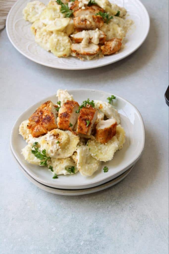 creamy saucy olive garden asiago tortelloni alfredo with grilled chicken garnished with finely chopped fresh parsley