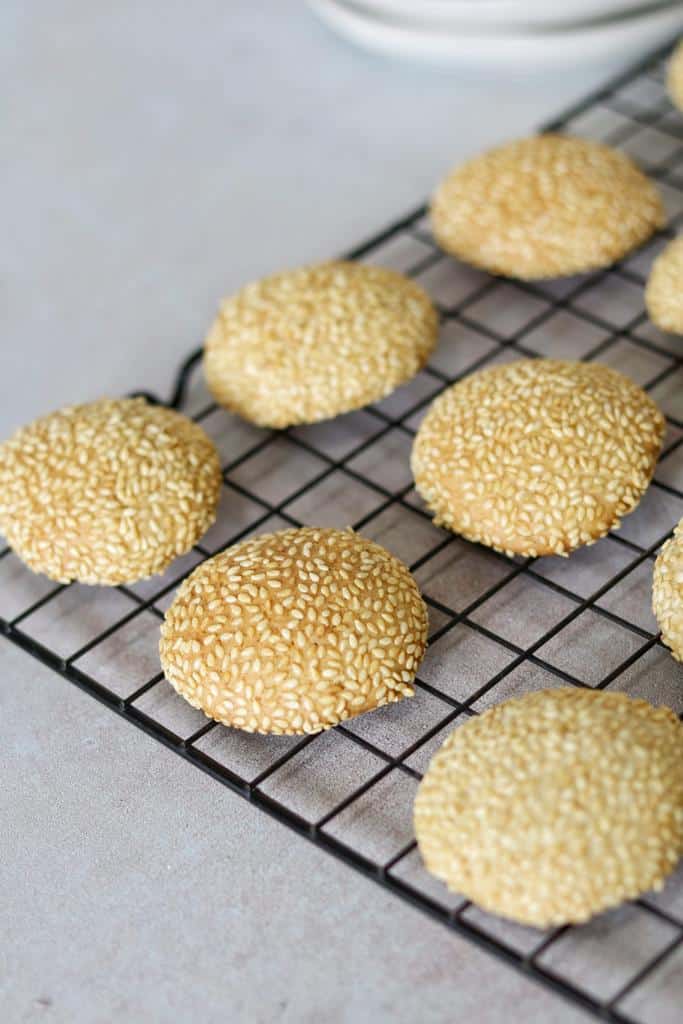 Golden baked middle eastern sesame seed cookies with crisp edges ready to be served with a glass of milk or with hot coffee.