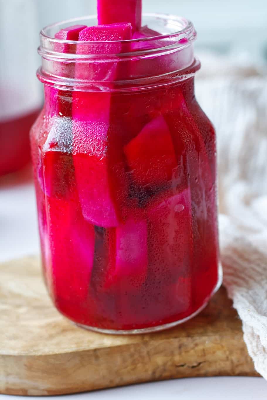 a jar of refrigerator pickled turnips having wonderful pink color and perfectly crunchy texture and yummy tangy flavor