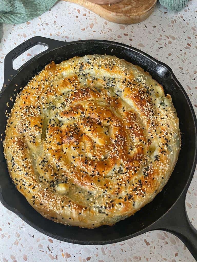 crunchy and flaky golden spinach and feta Borek garnished with Nigella seeds and sesame seeds 