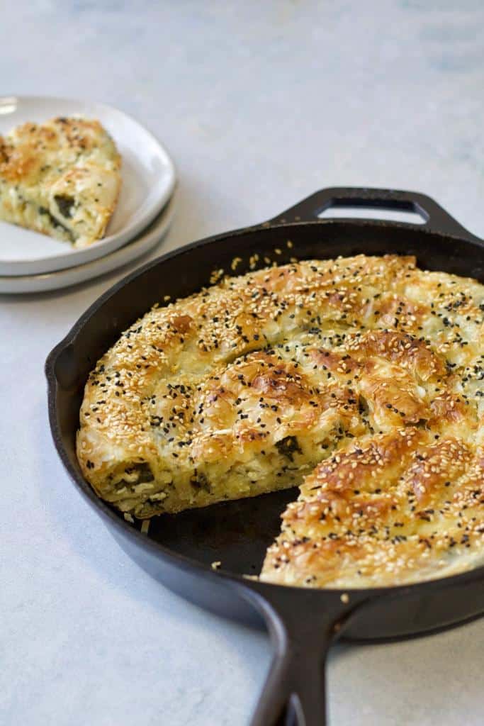 traditional Turkish Borek with cheese and spinach topped with Nigella seeds and sesame seeds