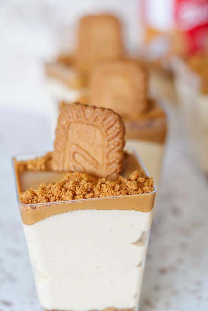 small cups filled with crushed biscoff biscuits, cream cheese filling, topped with lotus butter and some crushed biscoff biscuits