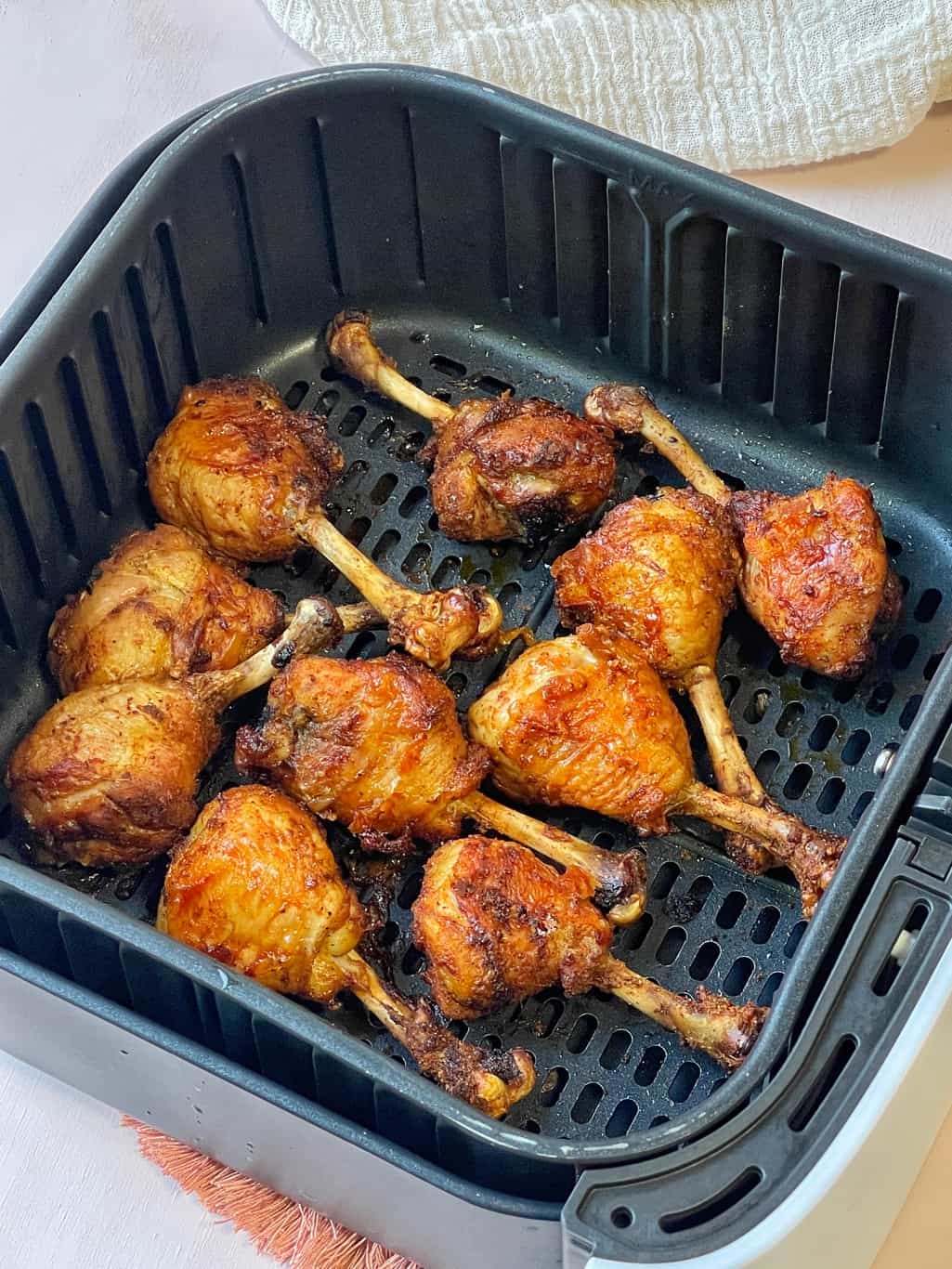 crispy chicken drumsticks in air fryer basket