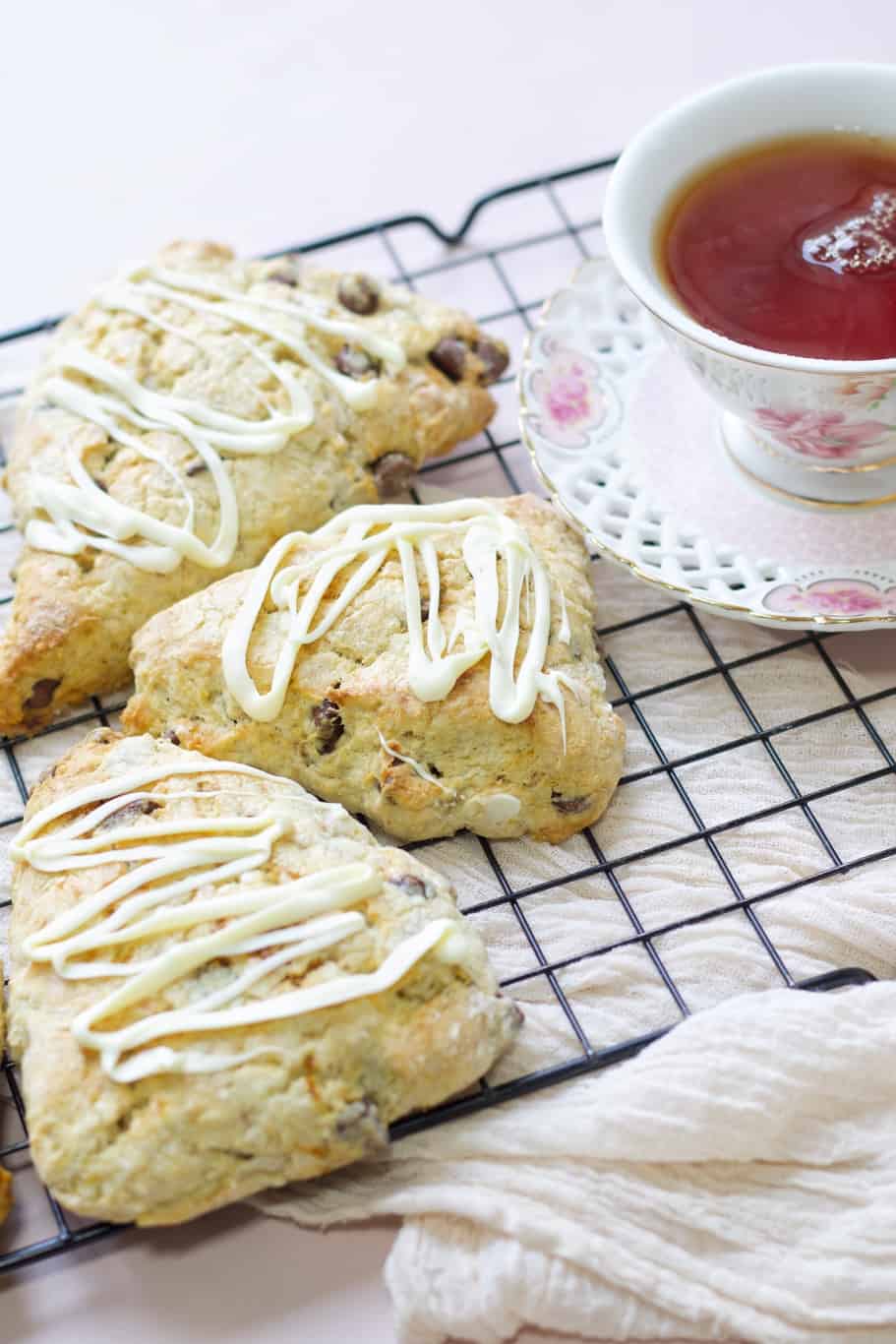 chocolate scones drizzled with melted white chocolate and served with a cup of tea