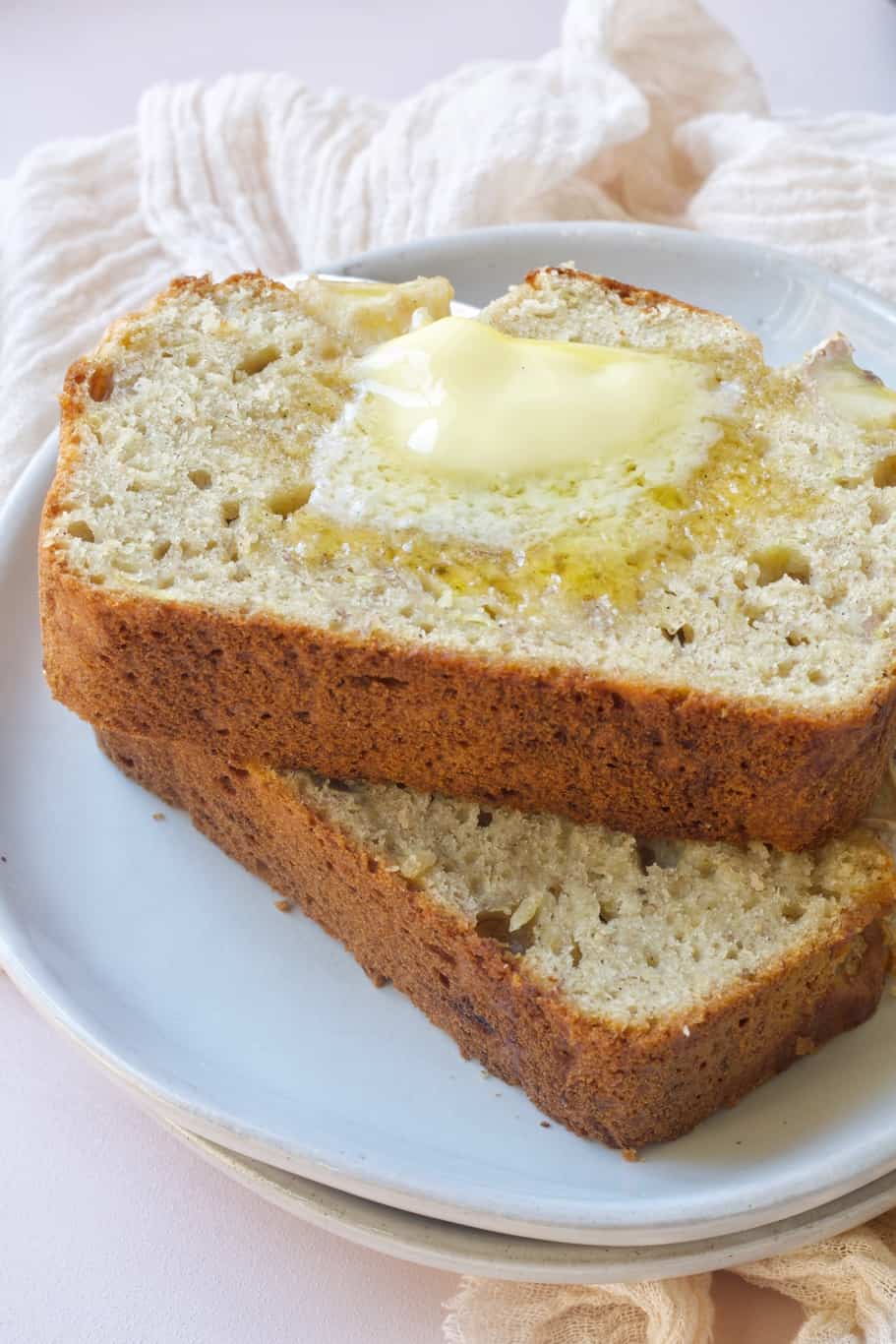 two slices of banana bread topped with a piece of melted butter make the perfect treat