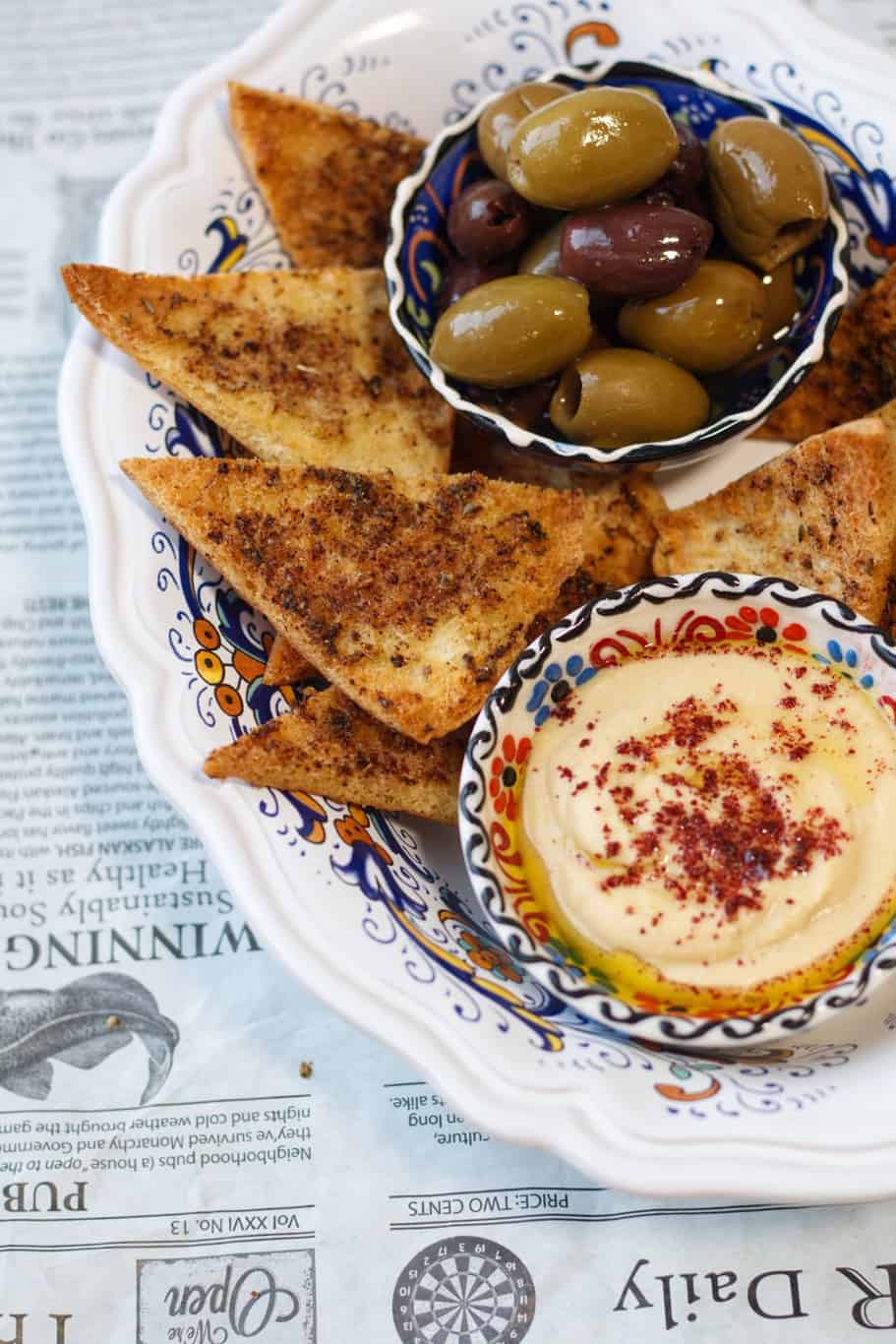 delicious crispy pita bread seasoned to perfection served with olives and hummus dip