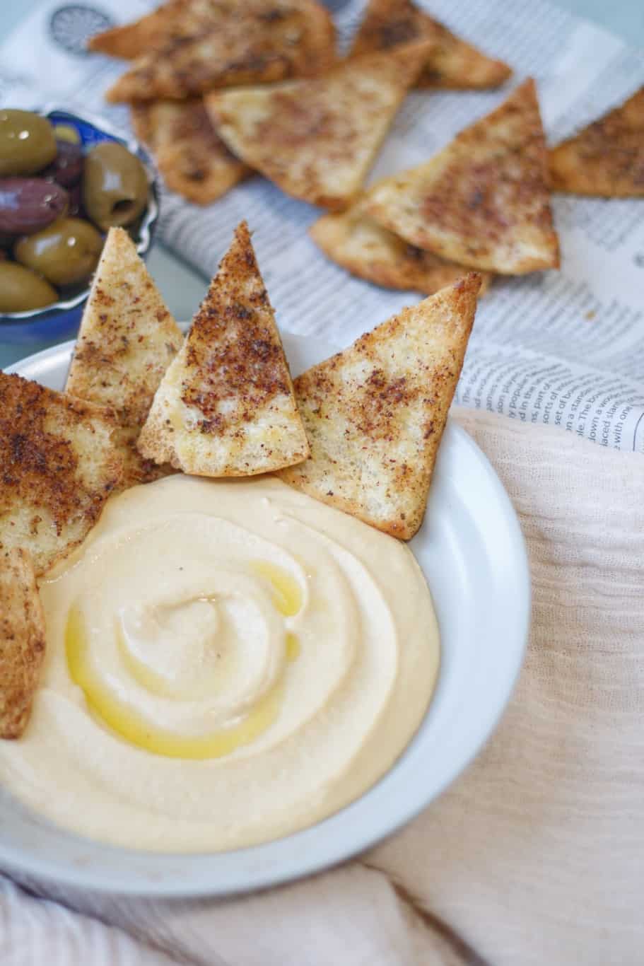 warm homemade triangles of pita bread with creamy lebanese hummus dip