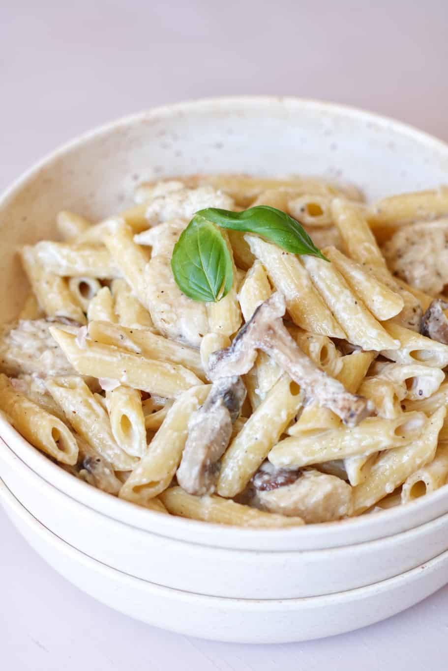 a creamy and cheesy bowl of pasta da vinchi with mushrooms, garlic, and caramelized onions