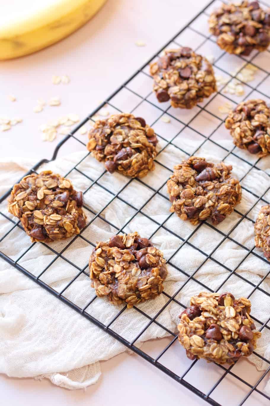 A bunch of Banana Oatmeal cookies placed on a cooling rack after baking.