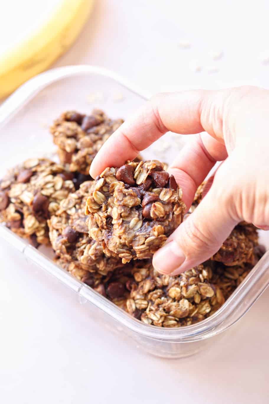 A container of freshly baked banana oatmeal cookies with chocolate chips. 