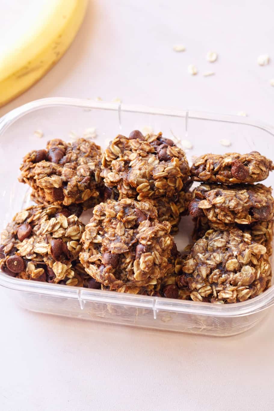 Pieces of leftover banana oatmeal cookies placed in an airtight container for proper storage.