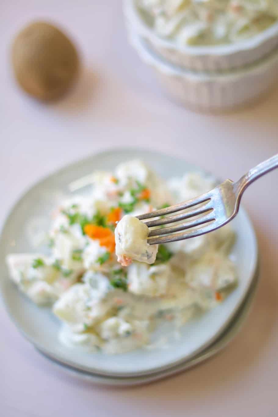 a bite a potato salad with creamy delicious mayo dressing