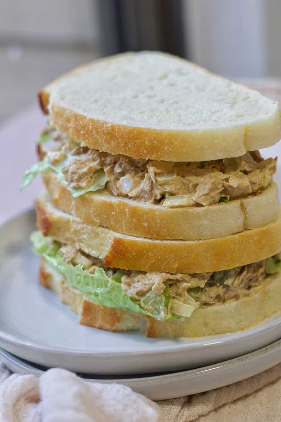 layers of crunchy bread stuffed with jimmy John's tuna salad and iceberg lettuce leaves
