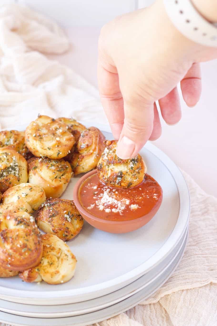 soft and pillowy parmesan bread bites dipped in marinara sauce
