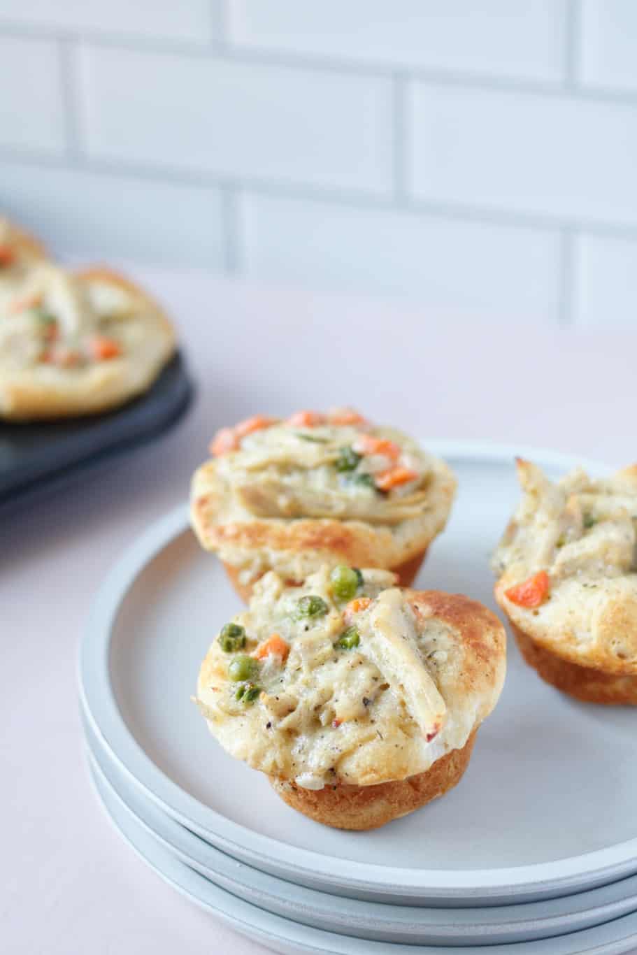 Mini chicken pot pies filled with chicken  and veggies and a creamy sauce and baked to golden perfection
