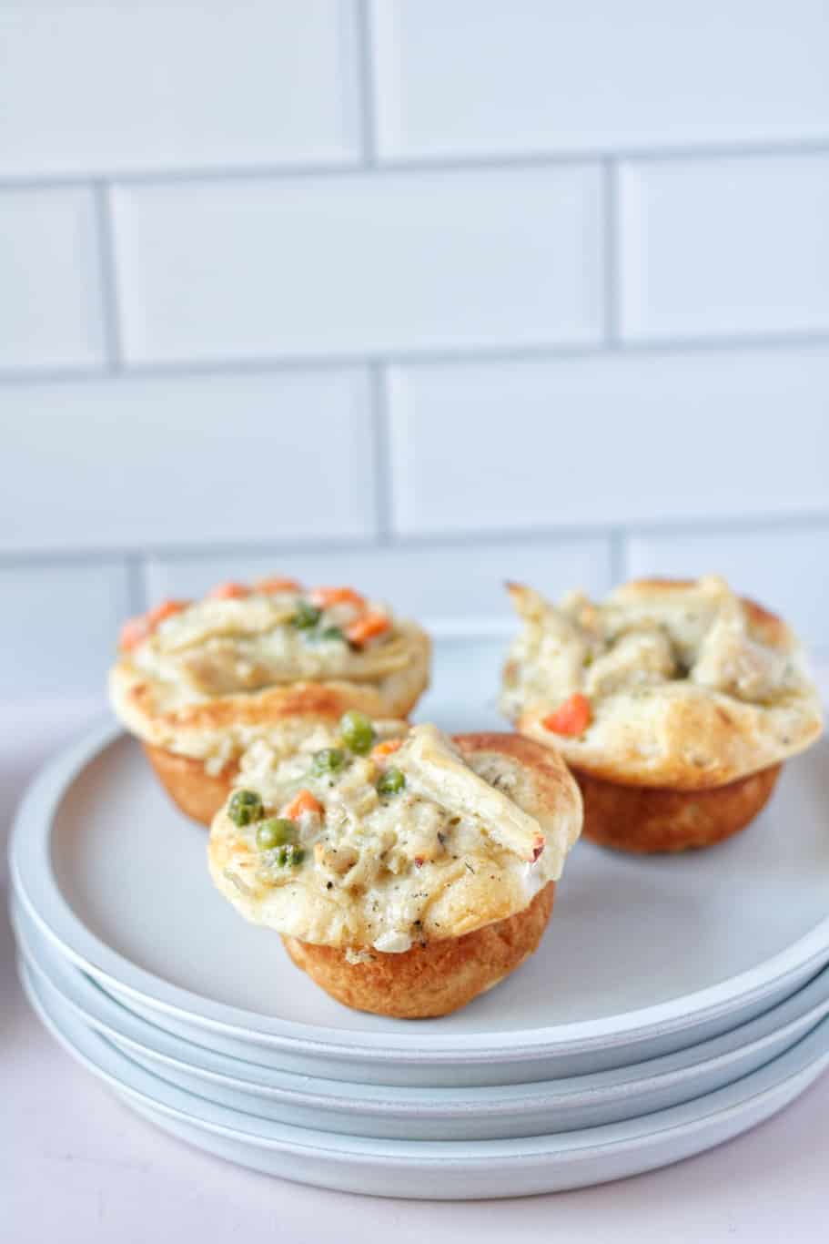 Individual flaky biscuits filled with tender chicken, a creamy filling, and crisp vegetables make an excellent make-ahead meal for your busy days.