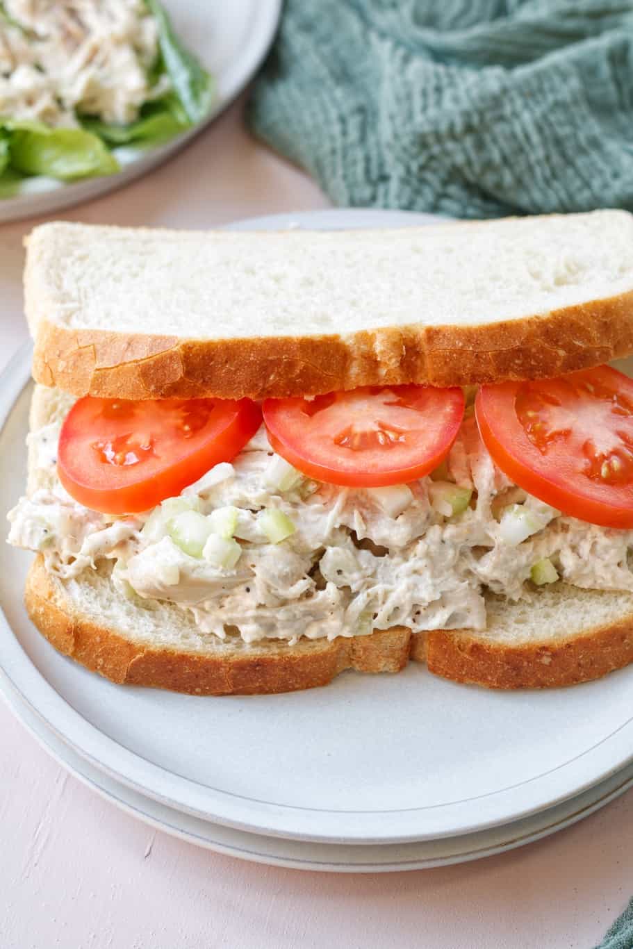zoes rotisserie chicken salad sandwich with fresh tomatoes on 7-grain bread