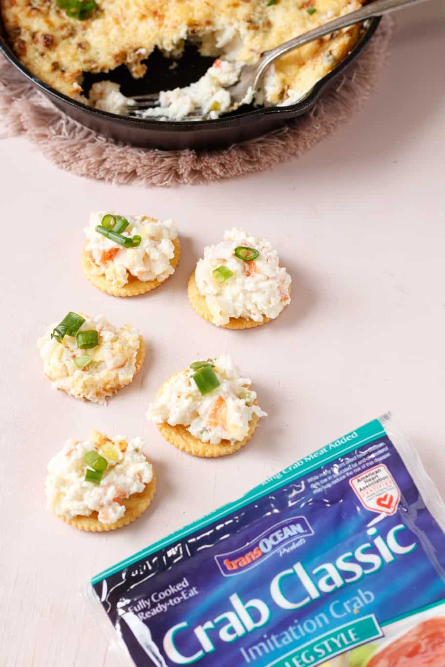 5 crackers topped with philadelphia cream cheese crab dipped and garnished with green onions