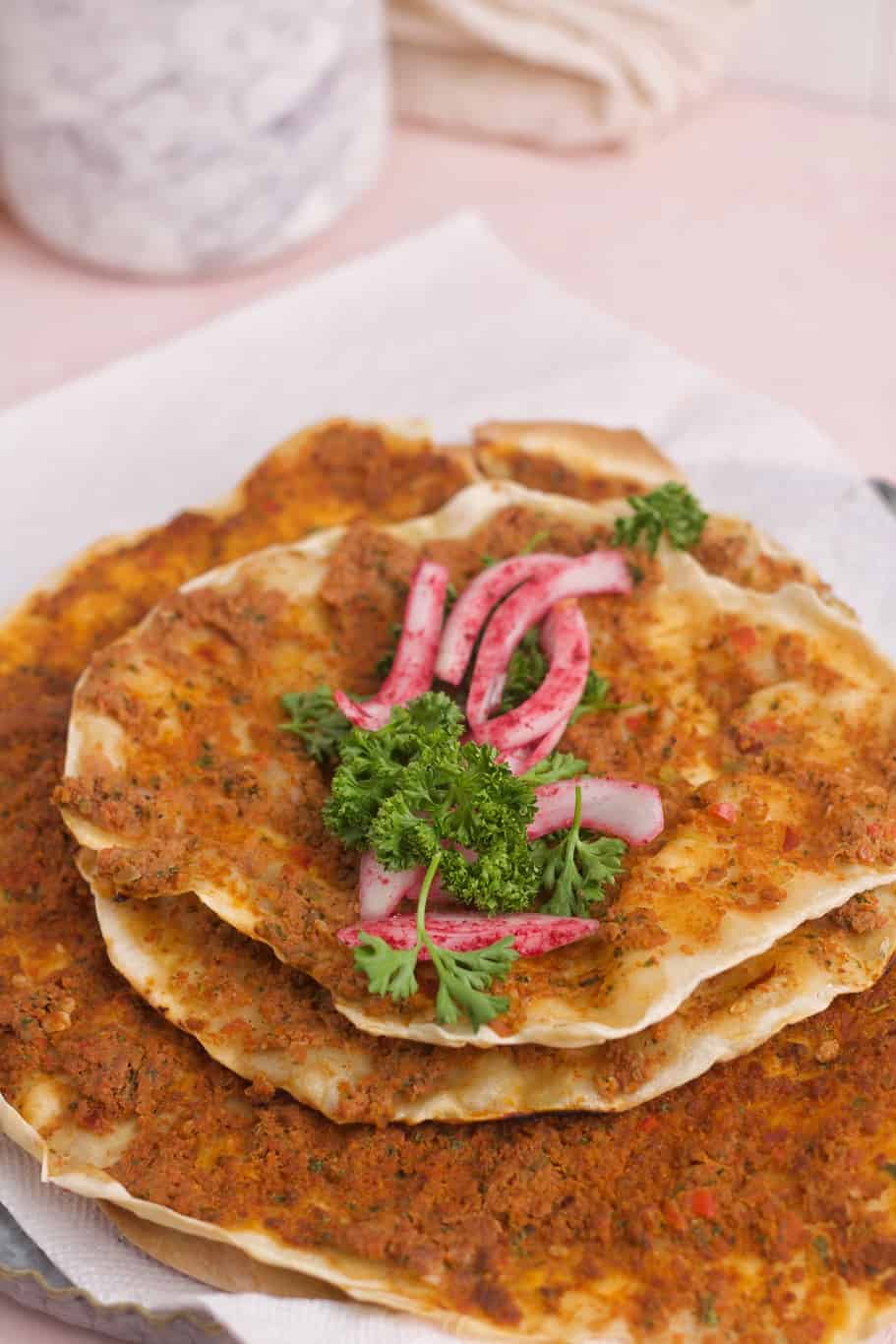 Turkish Lahmajoun wrap made with a mixture of juicy meat, veggies, savory spices, and seasonings and topped with onions and sumac
