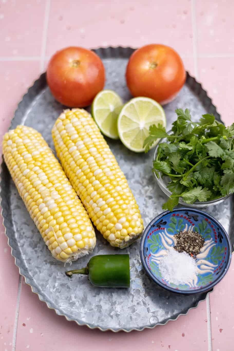 two ears of corns, tomatoes, cilantro, jalapeño, black pepper, salt, and lime are the essential ingredients to make the charred corn salsa recipe