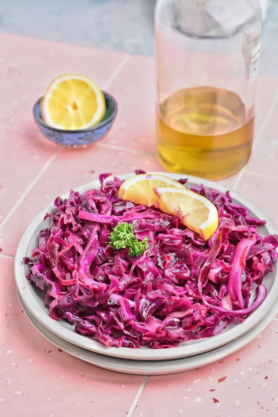 Turkish red cabbage salad garnished with lemon wedges 