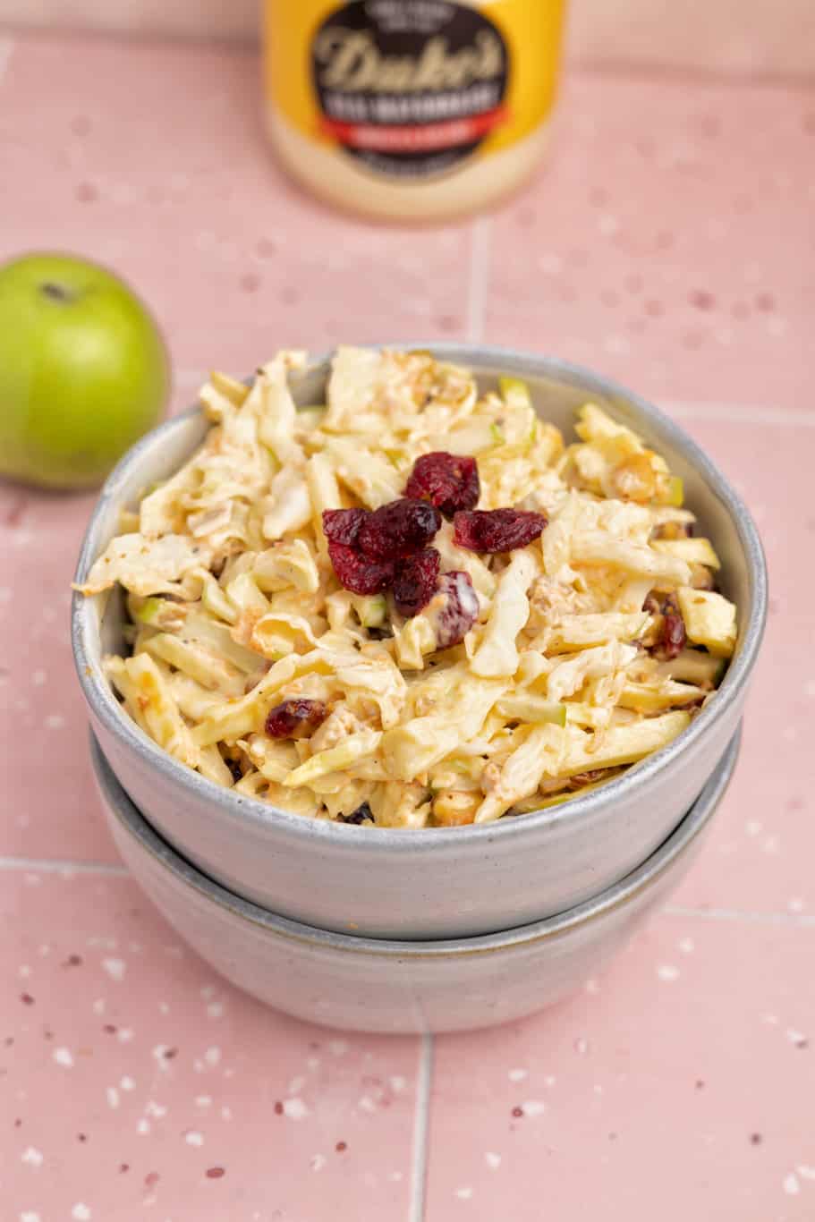 Coleslaw with Apples and Nuts is an easy salad made up of shredded cabbage, crisp apples, grated carrots, and crunchy nuts drizzled with a tangy dressing