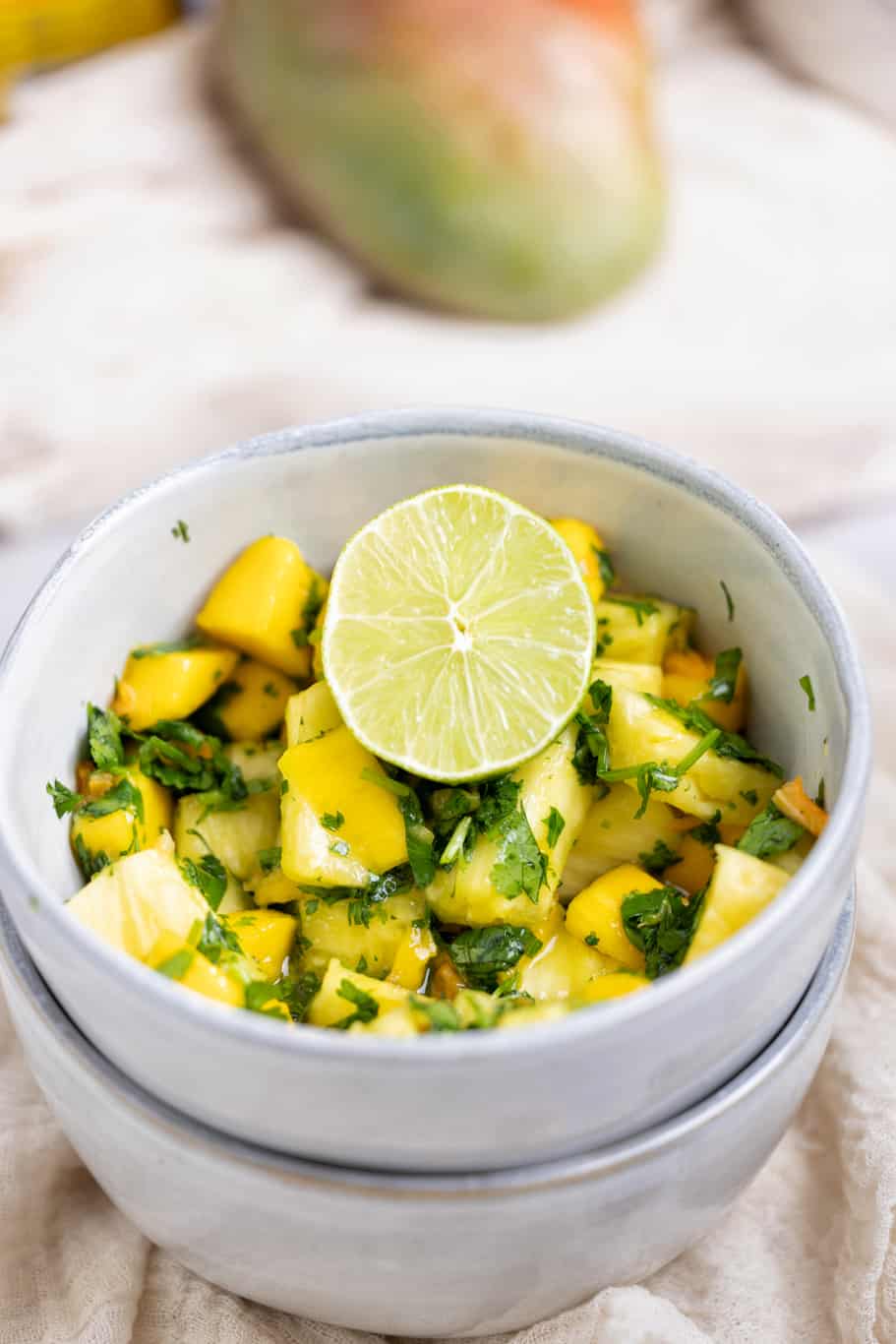 a small bowl of refreshing fruit salsa ready to be served with fresh lime