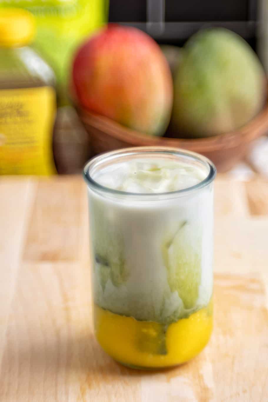 refreshing mango matcha drink served with ice cubes 