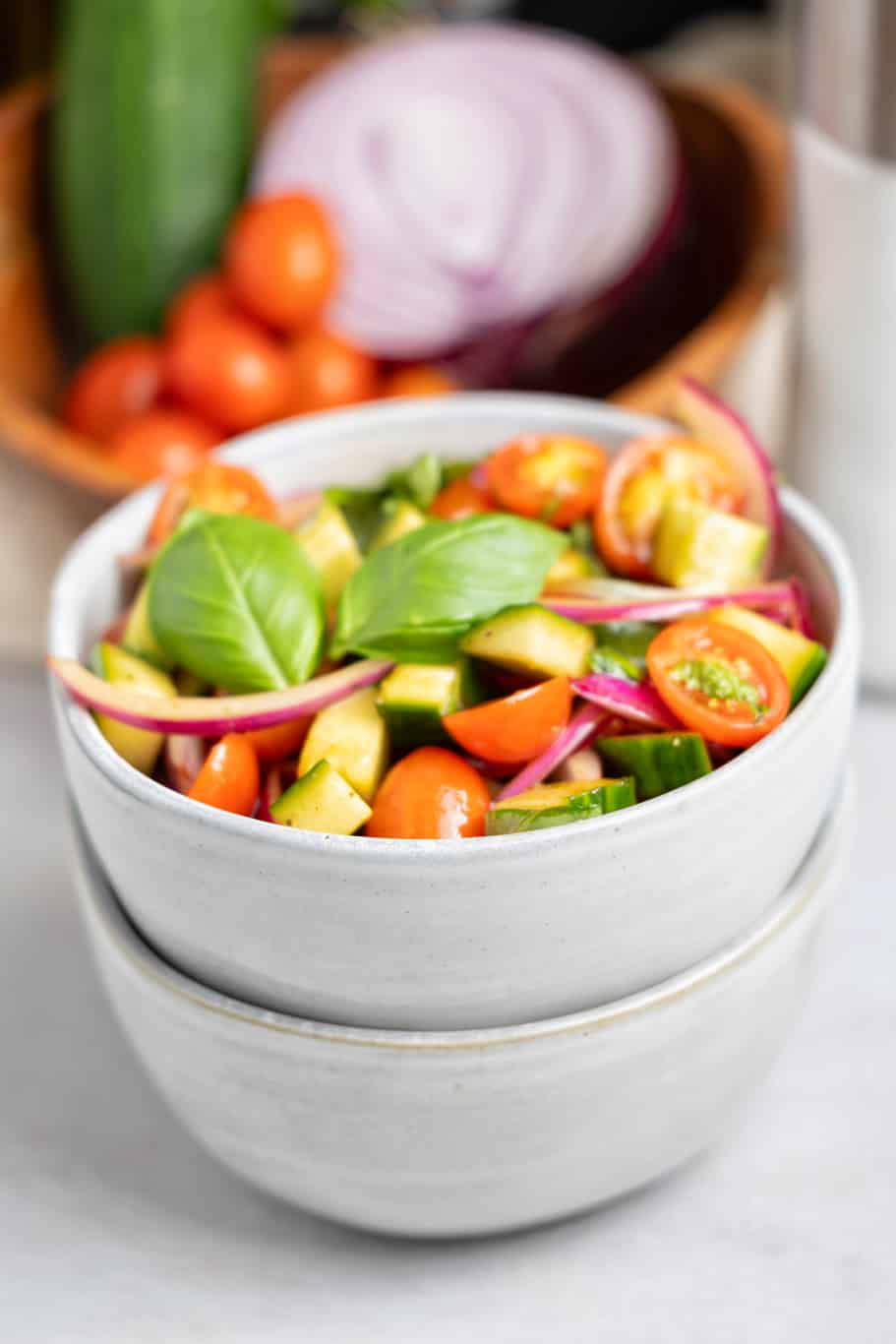 a small white bowl of refreshing colorful Panera tomato basil salad