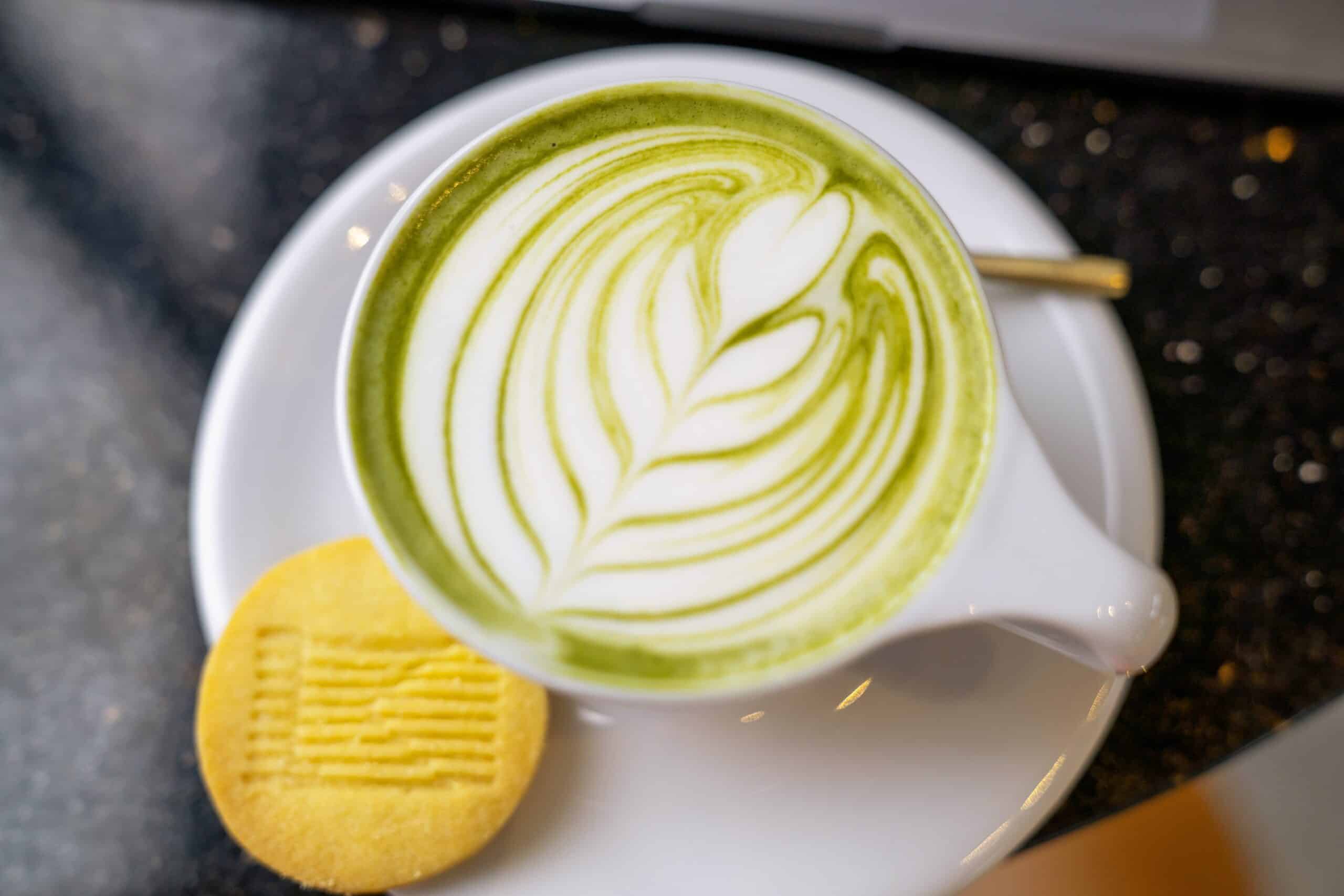 perfectly creamy matcha latte in a white cup