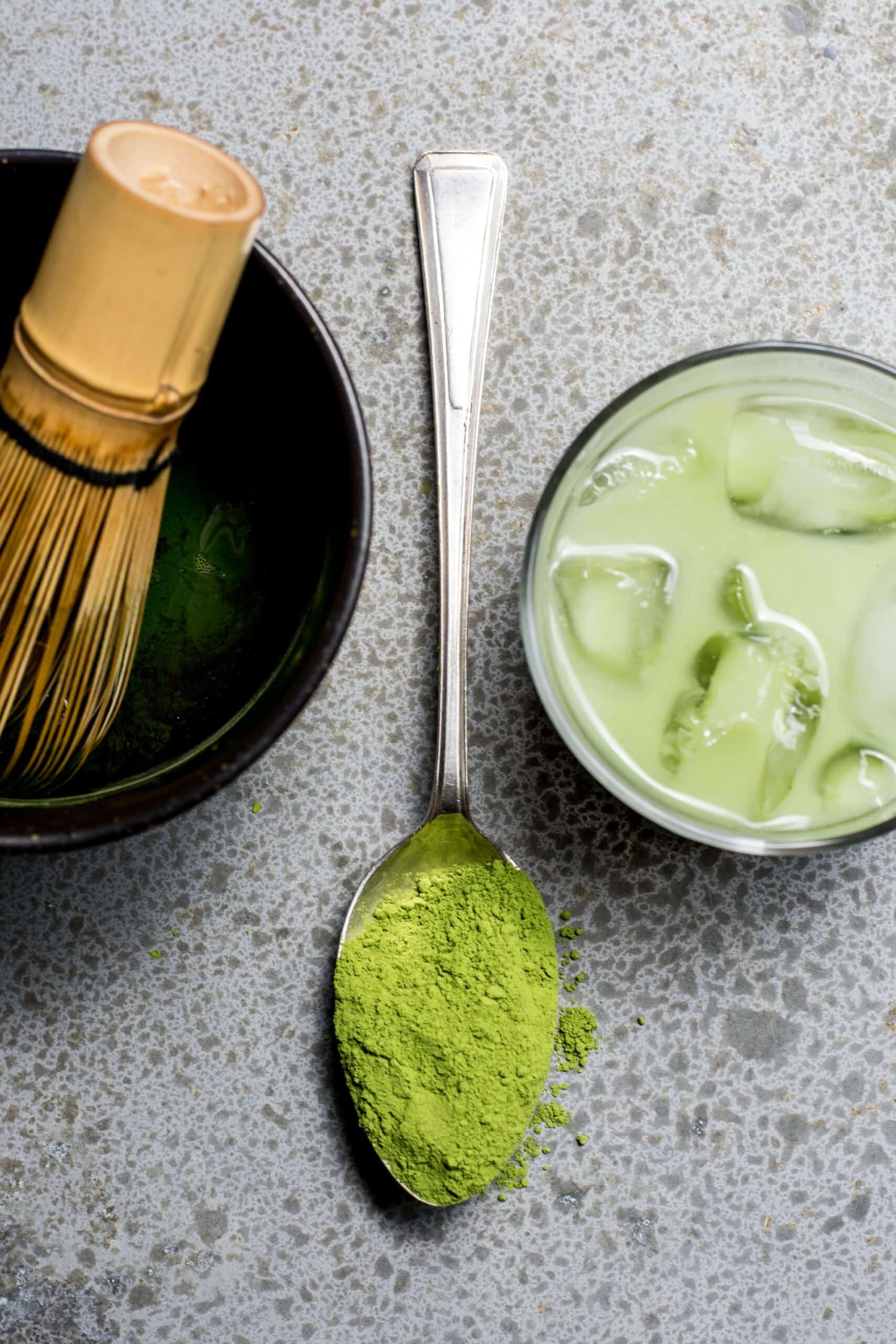 a cup of matcha latte and matcha powder