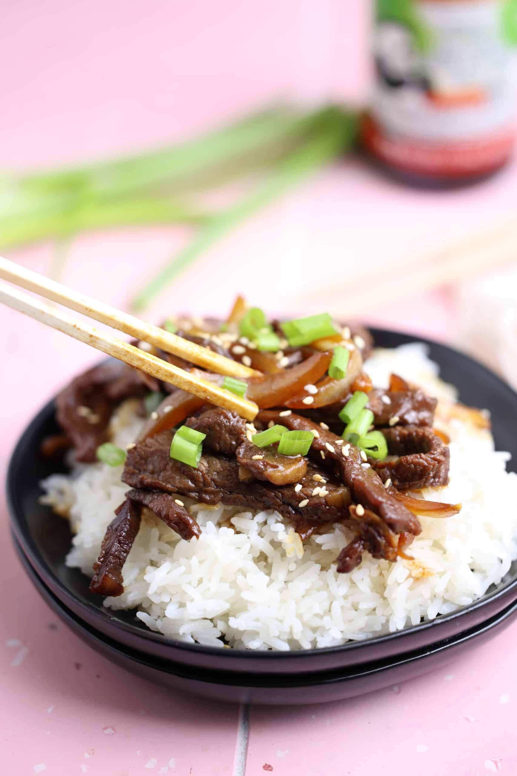beef and onion stir fry served on a bed of vermicelli rice